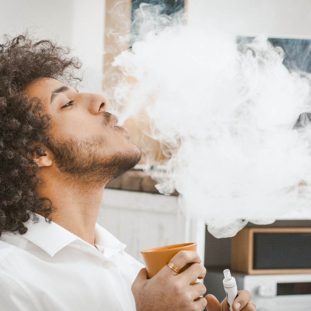 Man vaping and drinking water